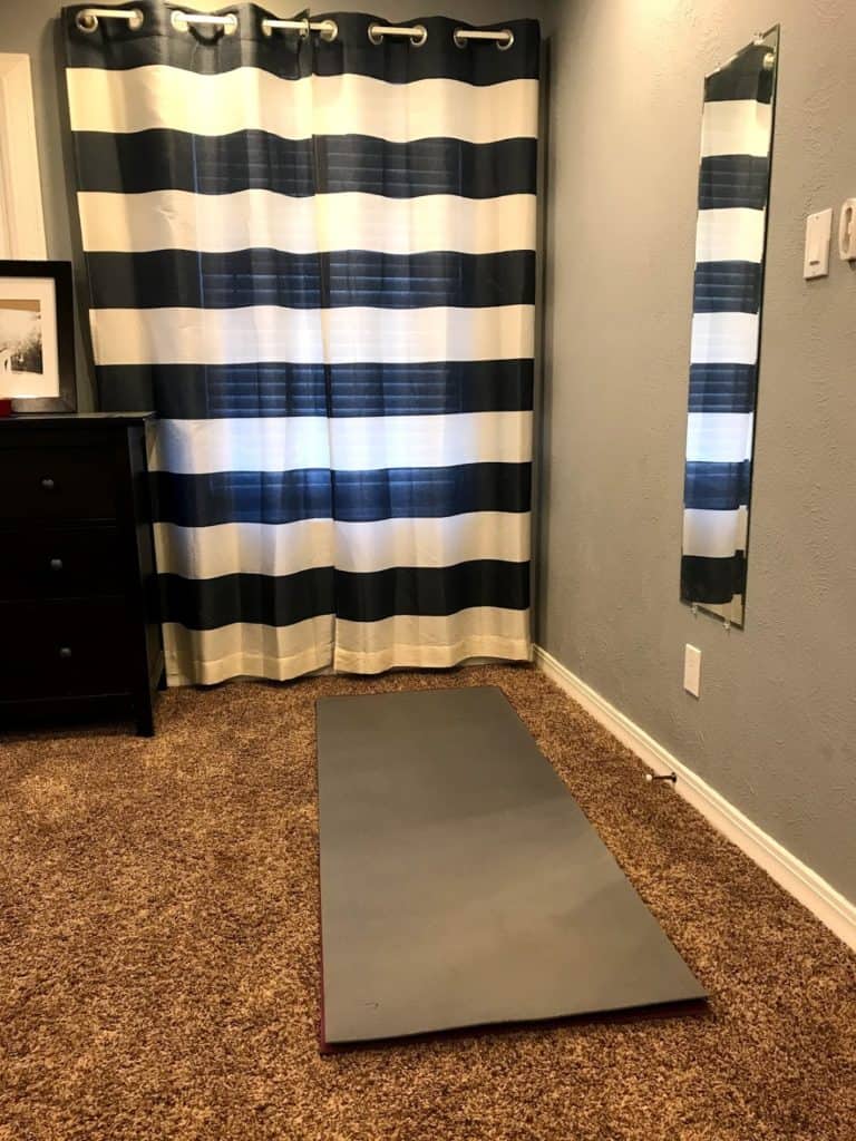 rolled out yoga mat in bedroom