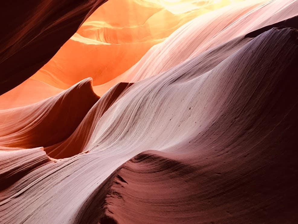 the walls of Antelope Canyon forming the shape of a wall fin disappearing into the ocean 