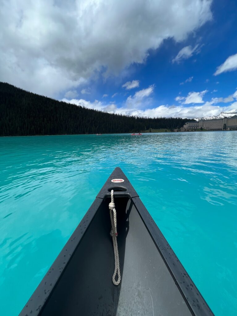 the bow of a canoe on the bright turquoise waters of Lake Louise