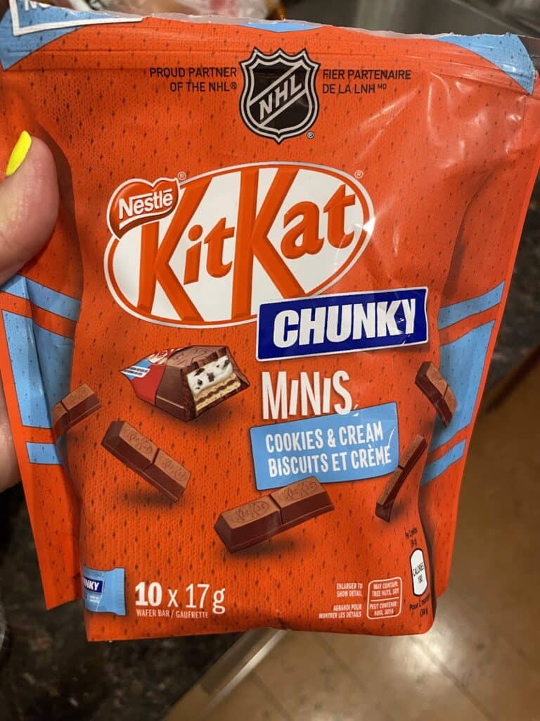a red bag of miniature kit-kat candy bars with white chocolate on the inside