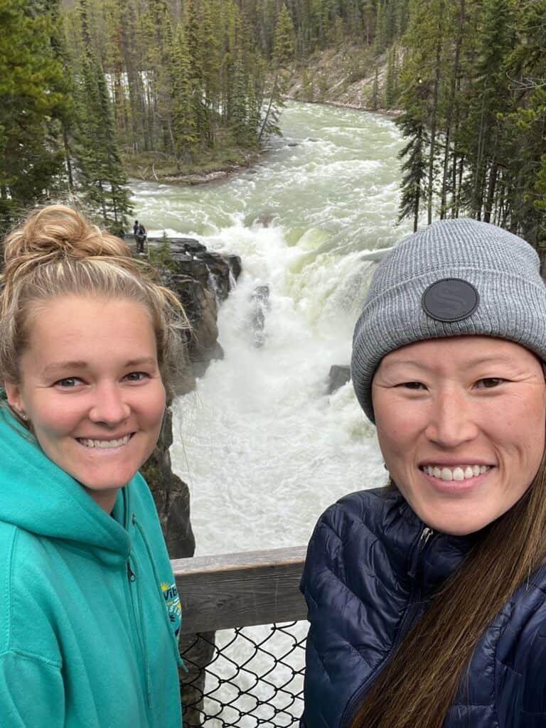 the author and friend stand in front of Suwapta Falls