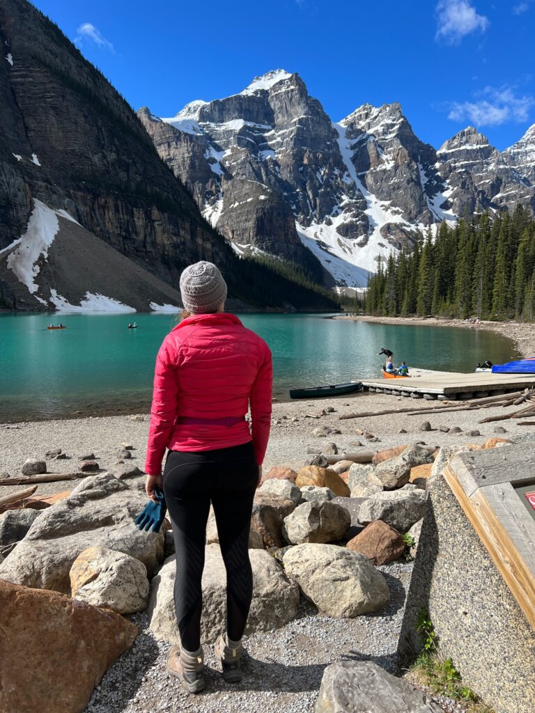 the author is standing on the shores of Moraine Lake looking out at the mountains in the distance