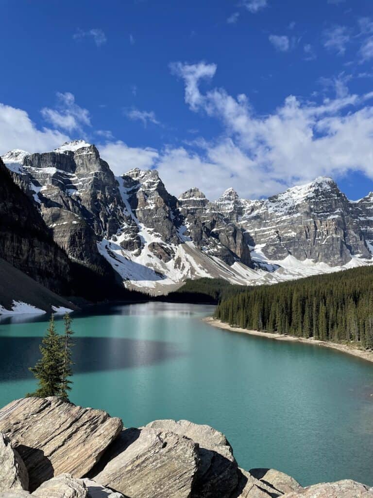 a scenic shot of Moraine Lake. The waters are still and there are no people around 