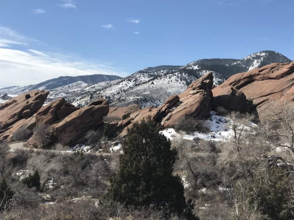 Red rock stack Colorado with snow covered mountains in the background