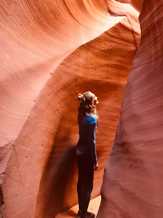 A woman standing in the light of Antelope Canyon
