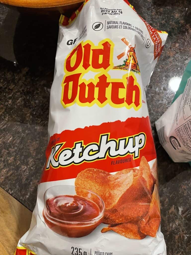 a red and white bag of Old Dutch ketchup chips 