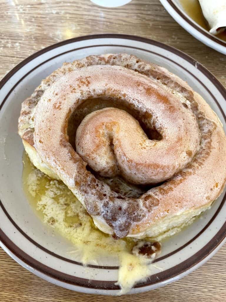 a cinnamon roll from one of the best breakfast spots in Albuquerque: Frontier Room
