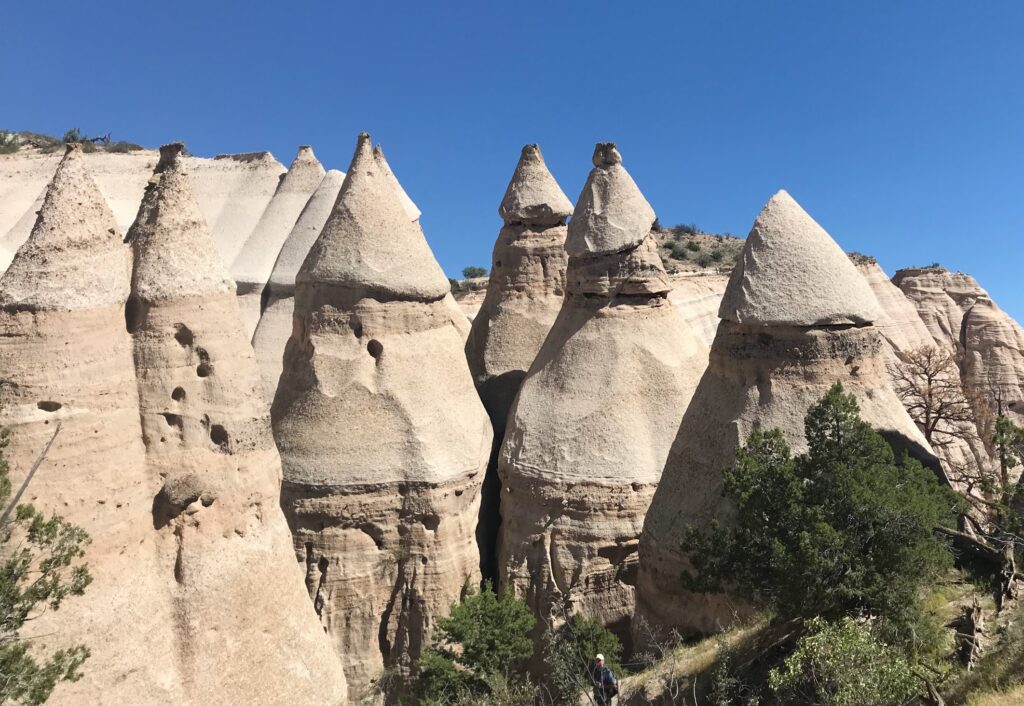 views of the rock caps and weathered white rock that has formed a cone shape at Tent Rocks, New Mexico
