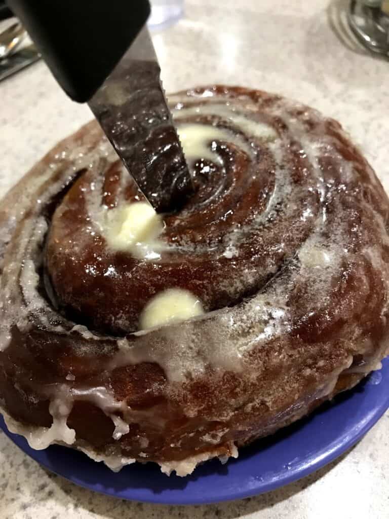 a giant cinnamon roll covered in butter and frosting from the Spic and Span Cafe, in Las Vegas New Mexico